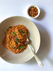 Pasta in a white round dish with a fork Caramelized Shallot Pasta Recipe