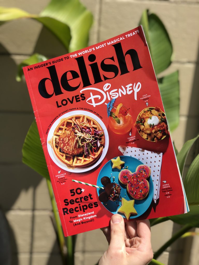 Red magazine with food dishes on the cover with green palms in the background