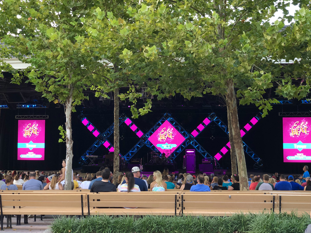 Purple light signs on a big stage for Epcot