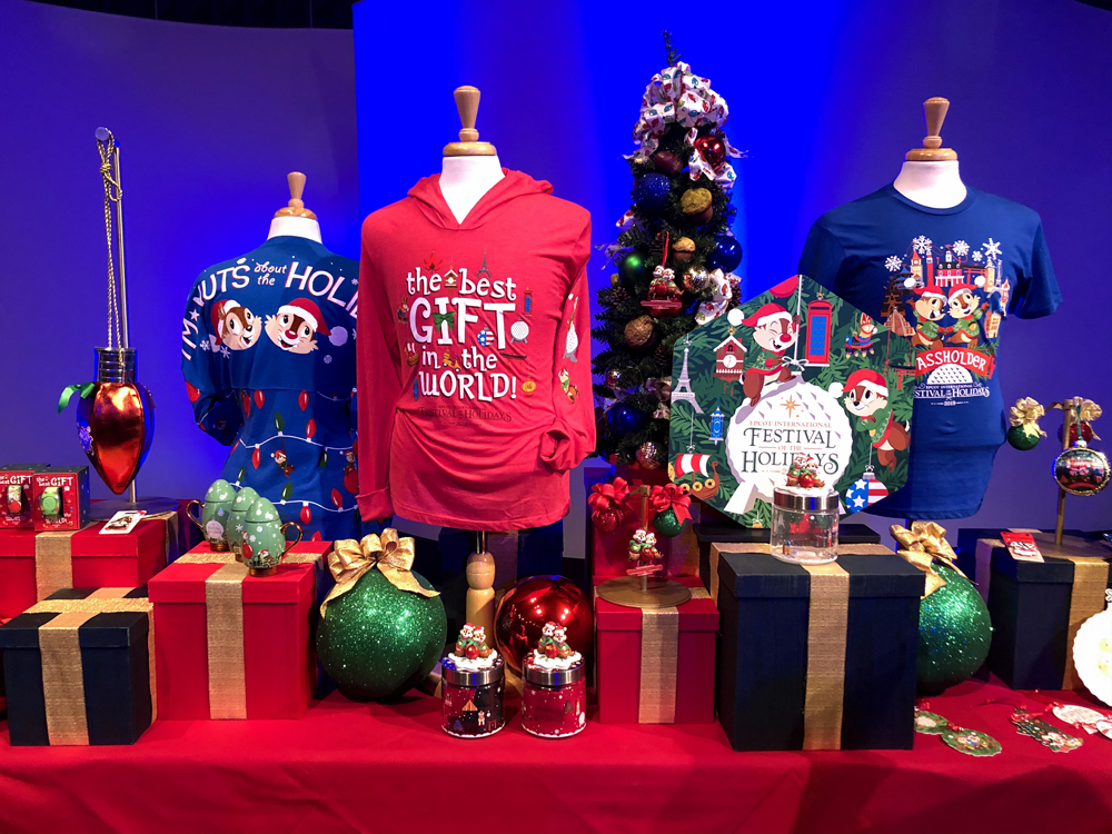 Blue and red shirts with green Christmas ornaments on a red table