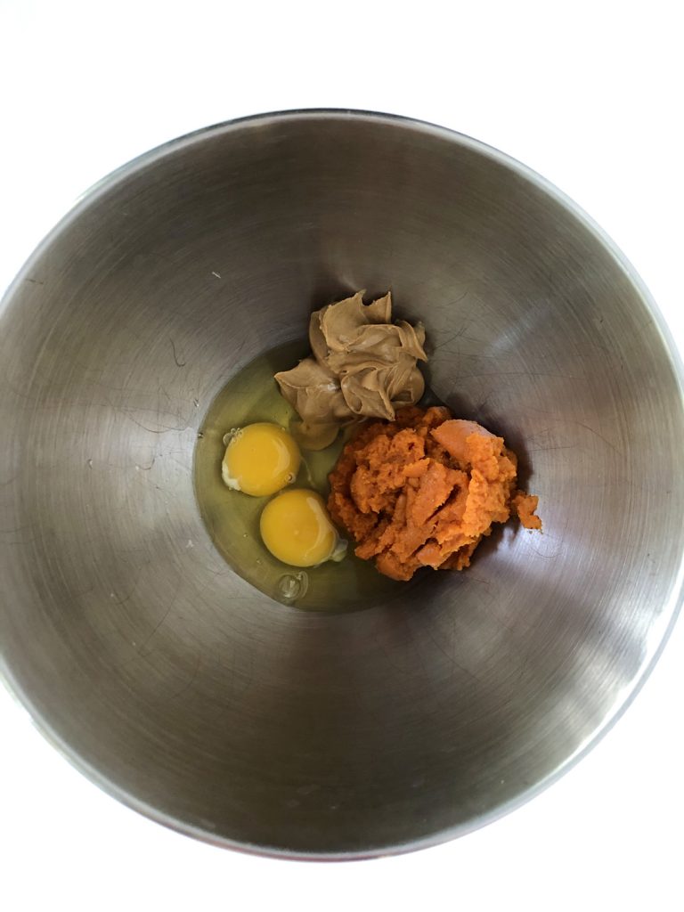 Eggs, Peanut Butter and Pumpkin Puree in a stainless steel bowl