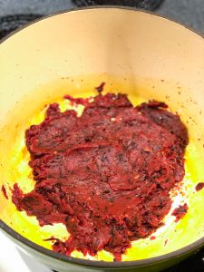 Red sauce with shallots in a green pot Caramelized Shallot Pasta Recipe